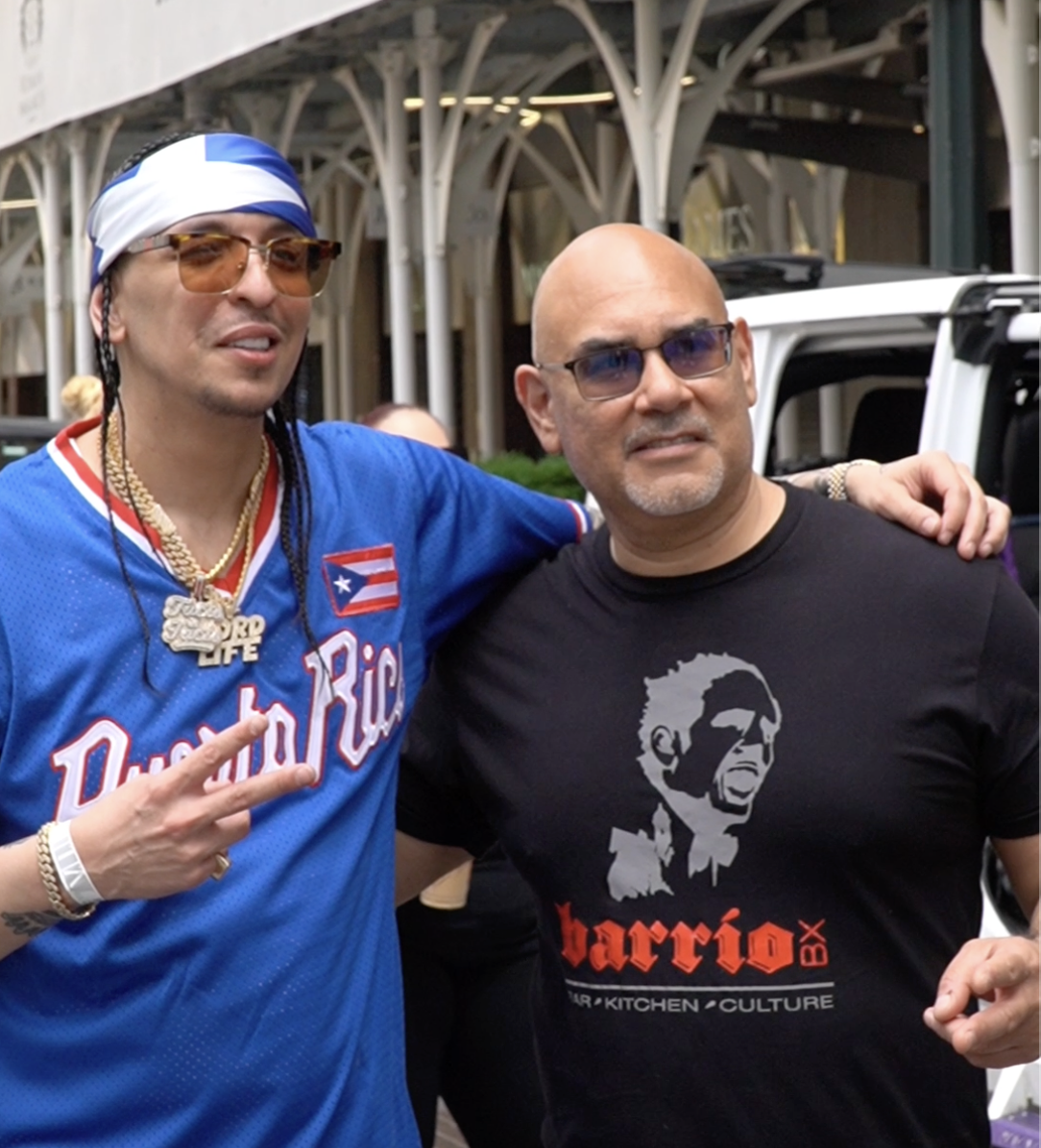 Artist posing with a guest outside a Bronx venue