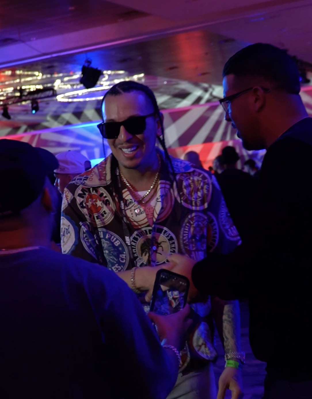Artist greeting fans in a neon-lit venue