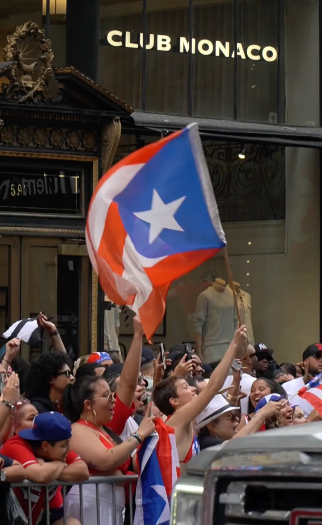 Puerto Rican flag waving over the parade crowd on Fifth Avenue