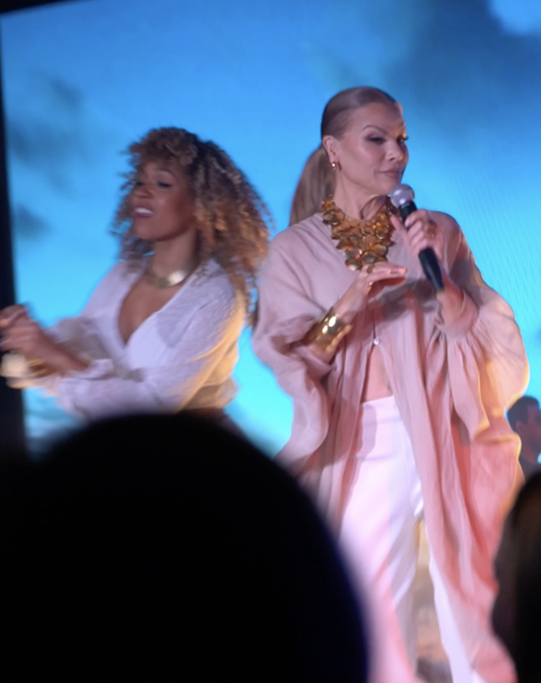 Performer singing on stage during a live event