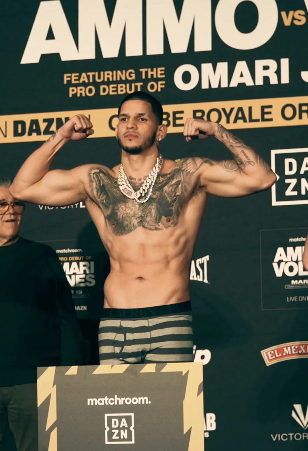 Fighter flexing on the scale at the official weigh-in